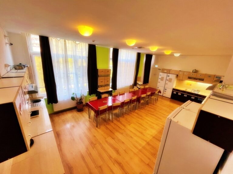 Spacious dining room and kitchen interior with modern furnishings.