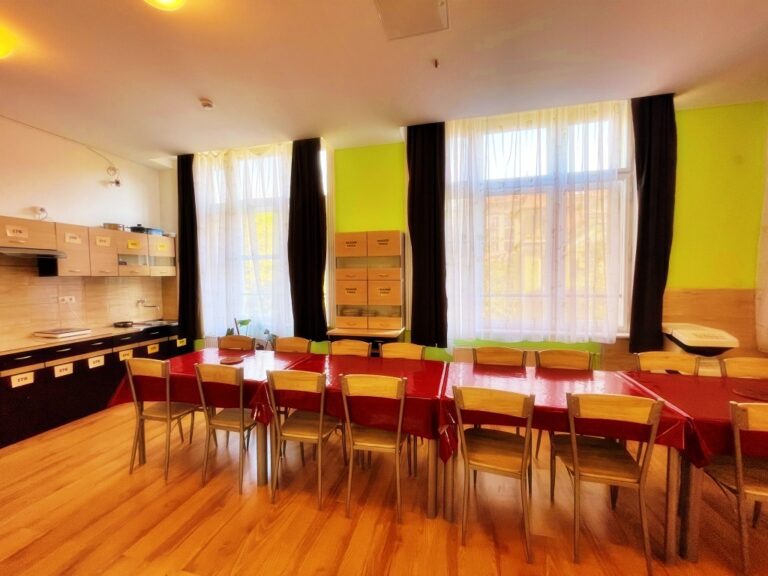 Spacious dining room and kitchen interior with modern furnishings.